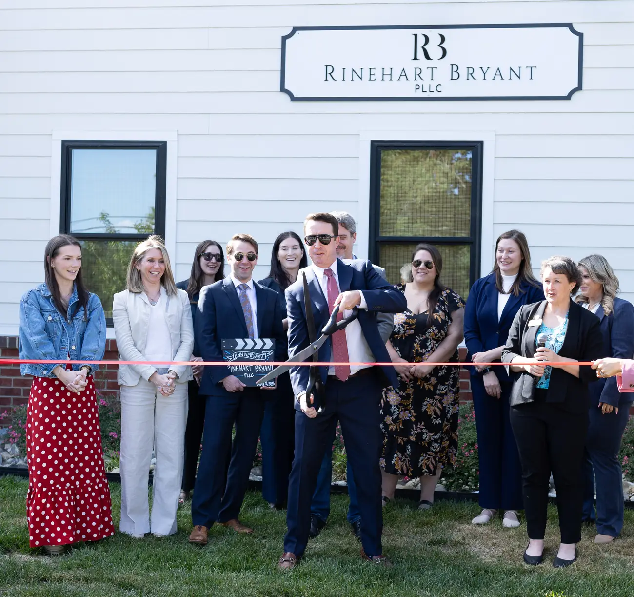John Bryant cuts the ribbon outside the Rinehart Bryant family law office in Spotsylvania Courthouse, Virginia